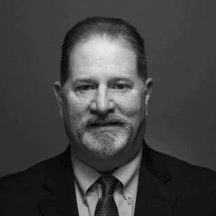 Black and white portrait photo of Thomas J. Henry Attorney Gregory A. Stewart