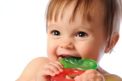 Blog 4 Baby smiling while chewing on a teething ring
