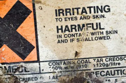 Label warning that on a container of creosote indicating it to be harmful and a chemical irritant.