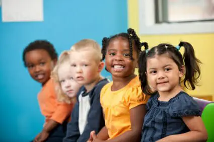 Blog 14 Group of five young boys and girls sitting down and smiling