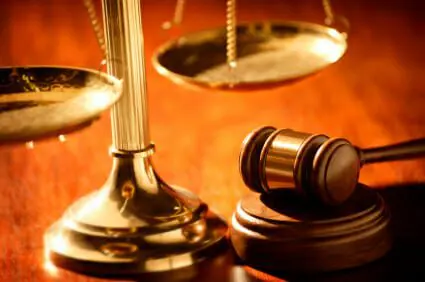 What if I am Partially to Blame for my Injuries Caused by Another Person? 1 Golden scales and gavel on wood desk