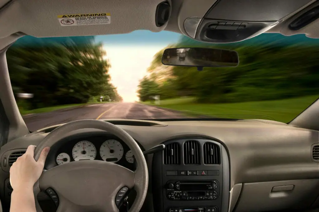 First person view of driver in a car looking out through the front window