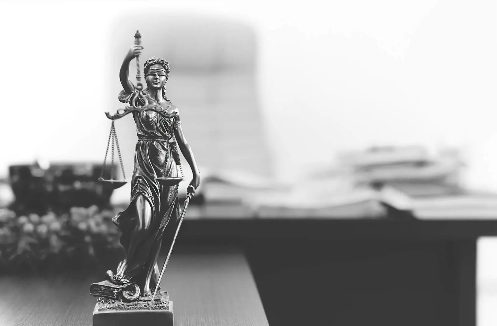 Three More Scammers Confess Involvement in Staged 18-Wheeler Accident Case 1 Statue of Themis holding scales of justice in lawyer's office