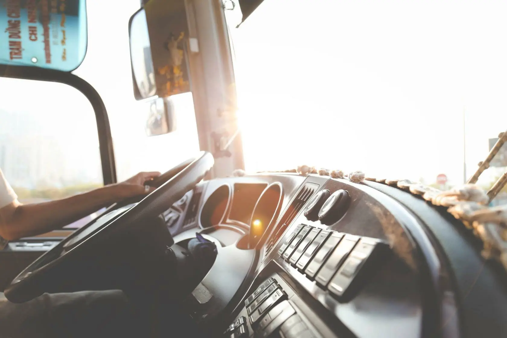 Blog 12 Public transit bus dashboard with driver's and holding the steering wheel