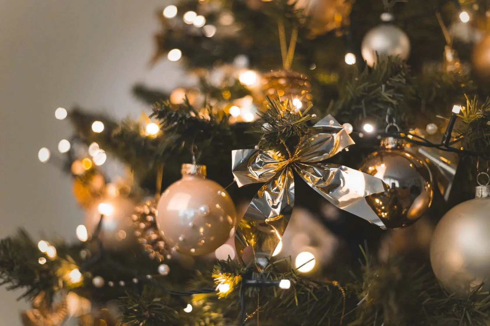 Blog 10 Christmas tree with gold ornament and a ribbon