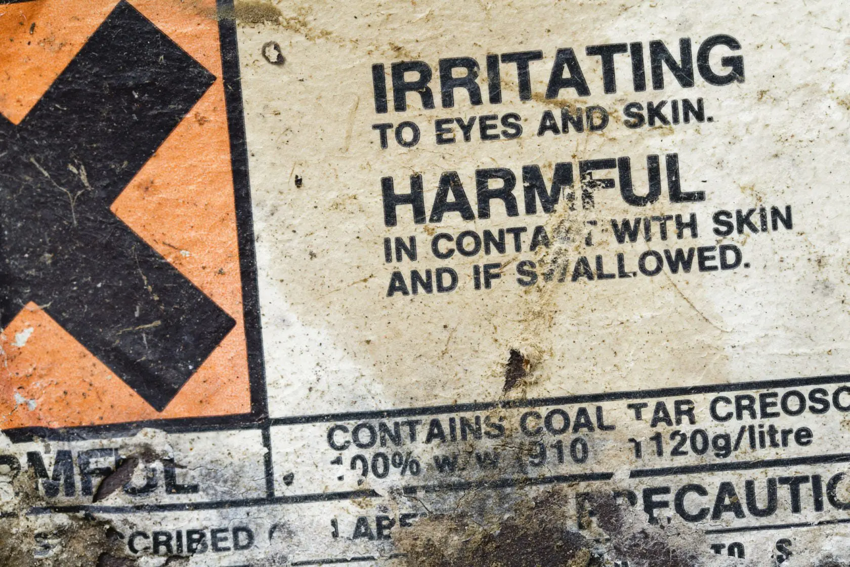 Blog 2 Warning label on a container of creosote indicating it to be harmful and a chemical irritant.