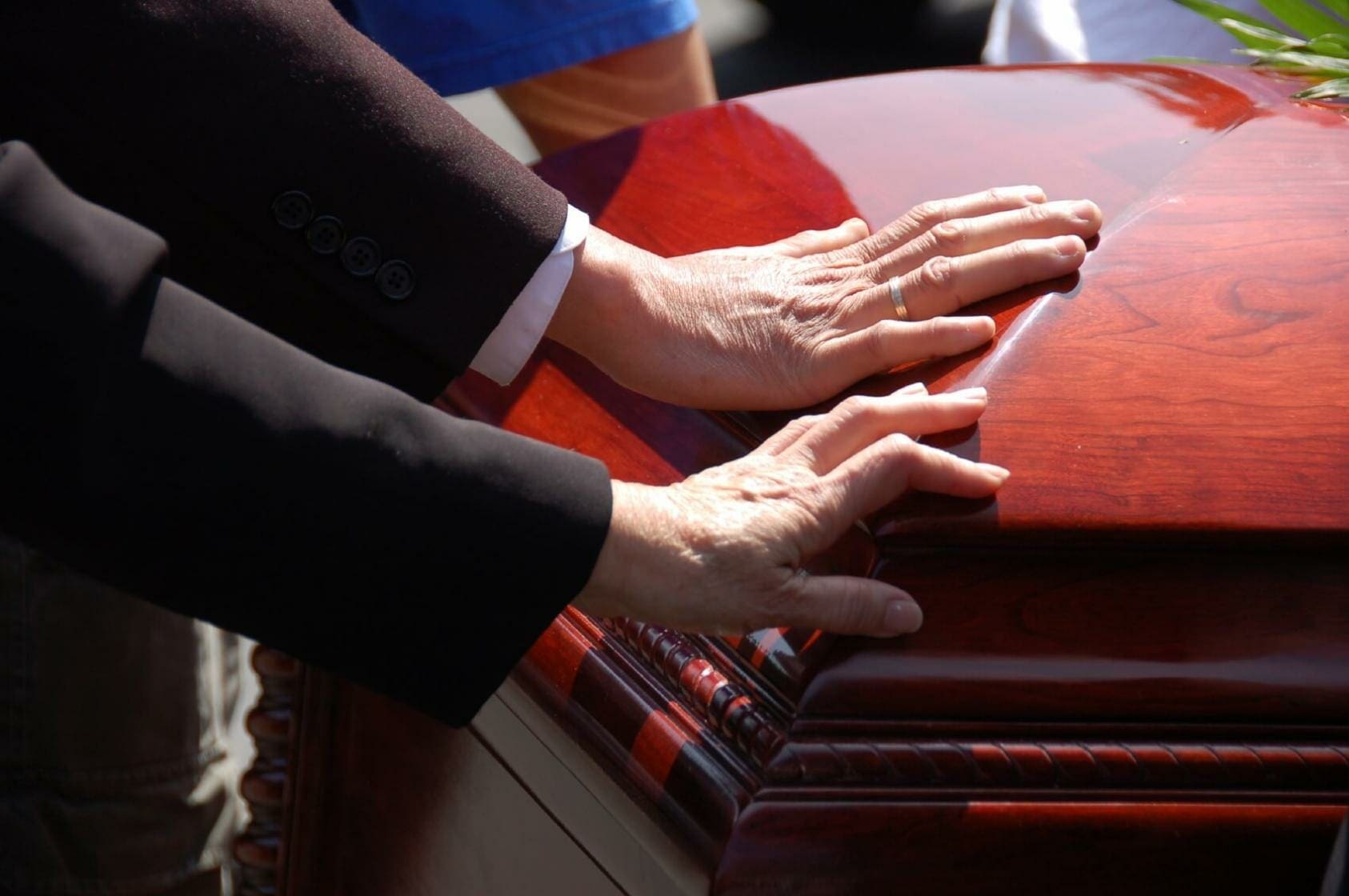 One Dead in Washington, D.C. Construction Accident 1 Two hands on funeral casket