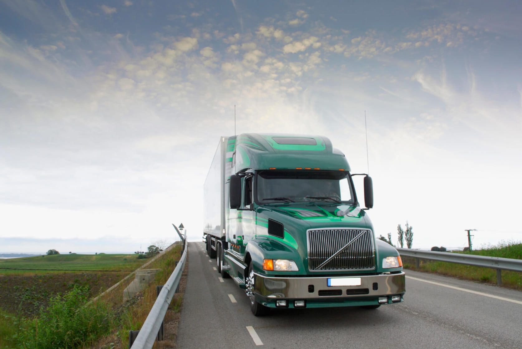 Are Employers Responsible for Car Accidents Caused by Their Employees? 1 Green 18-wheeler traveling on open road