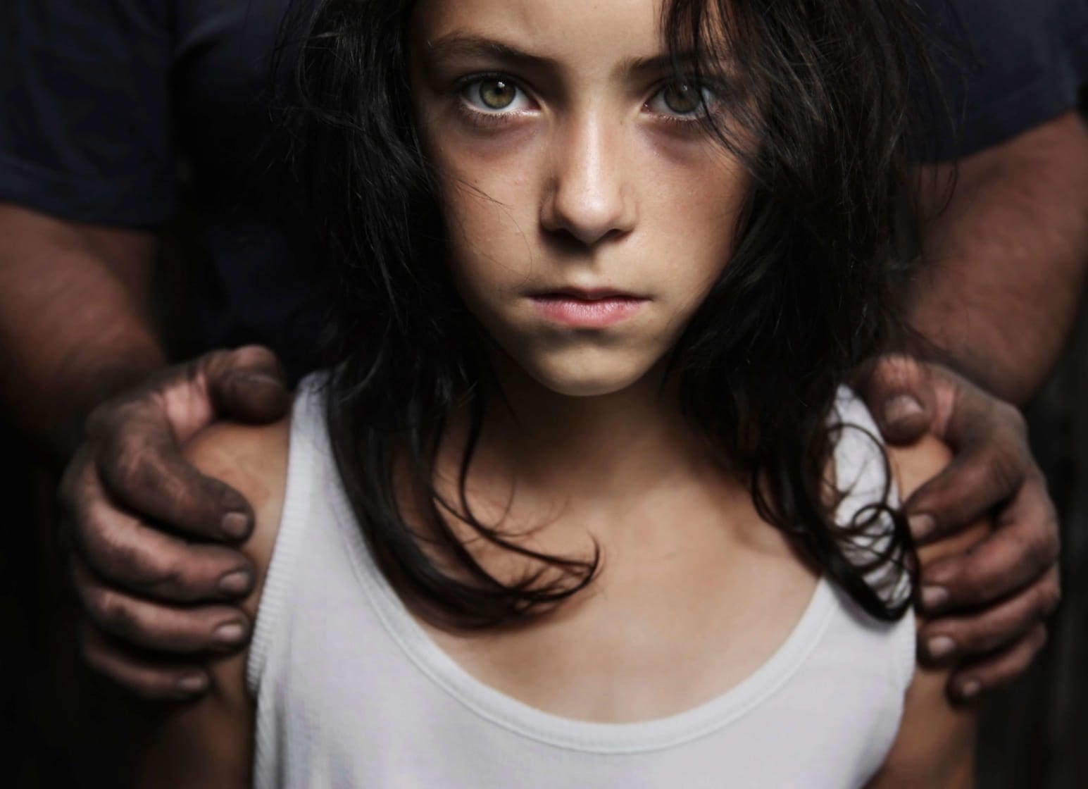 Teen girl being held between two hands