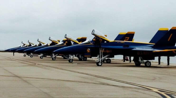 Thomas J. Henry Proud to Present Wings Over South Texas Air Show 1 Blue and yellow jets on runway