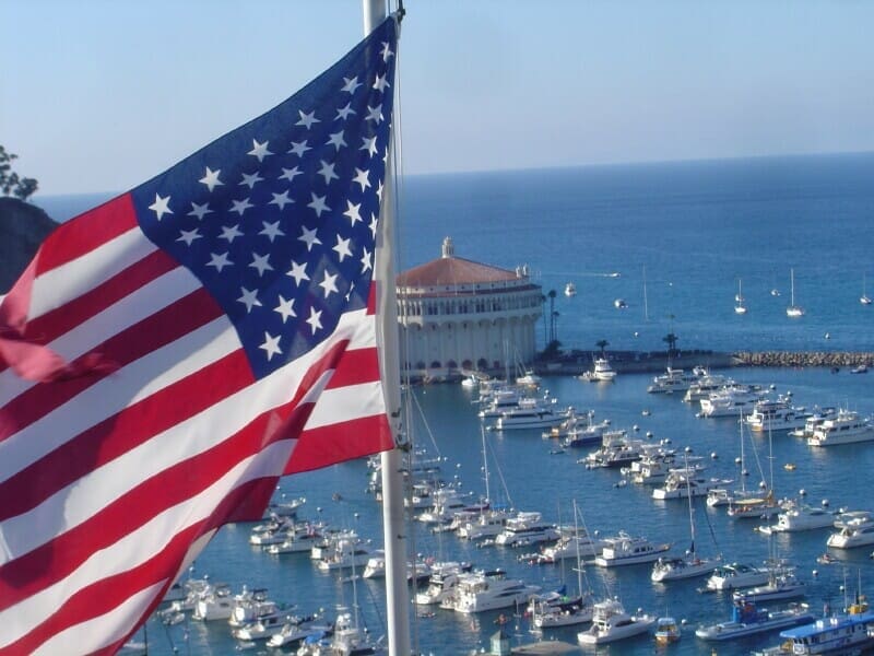 Rear-End Collisions in Texas: Who's Really at Fault? 2 American flag over port with numerous docked boats