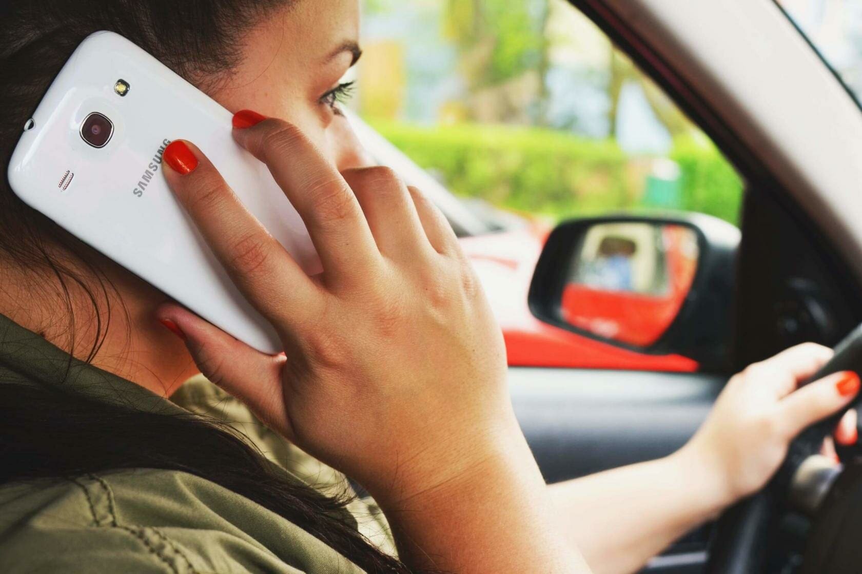 Distracted Driving Awareness: The Three Types of Driver Distraction 1 Woman talking on Samsung phone while driving