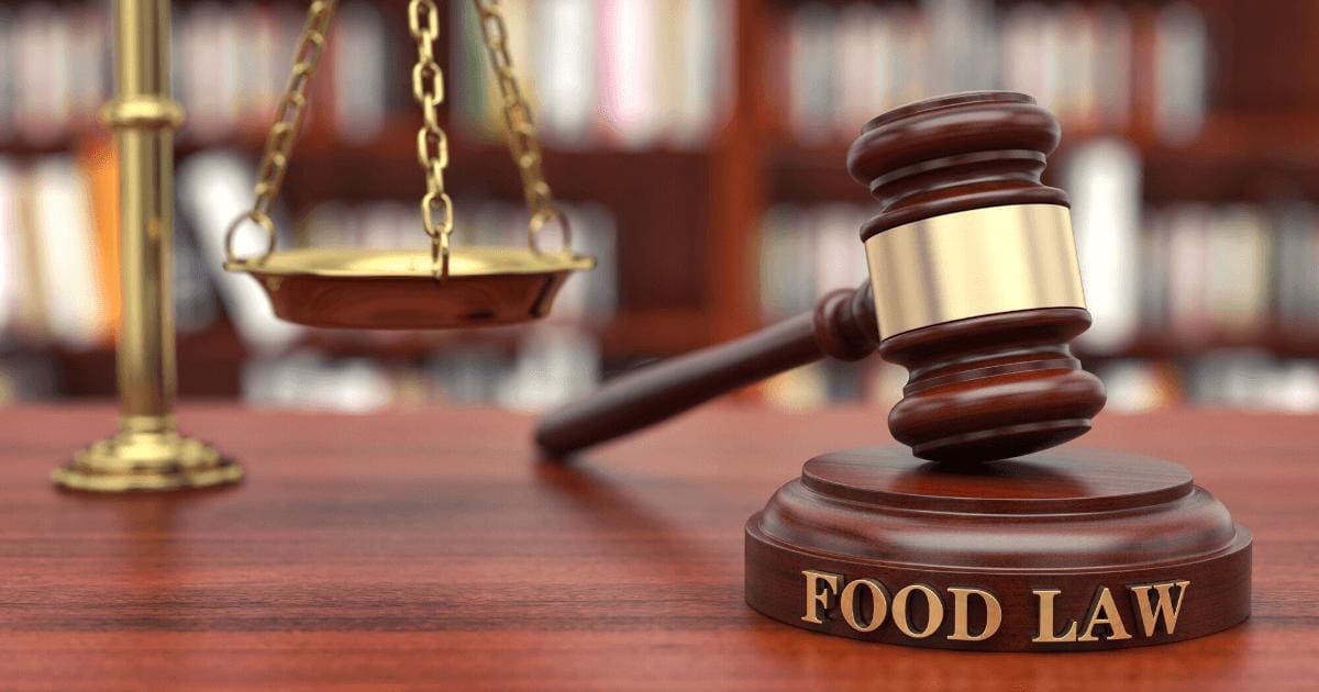 Rear-End Collisions in Texas: Who's Really at Fault? 14 Gavel with "Food Law" embedded on it and gold scales on desk