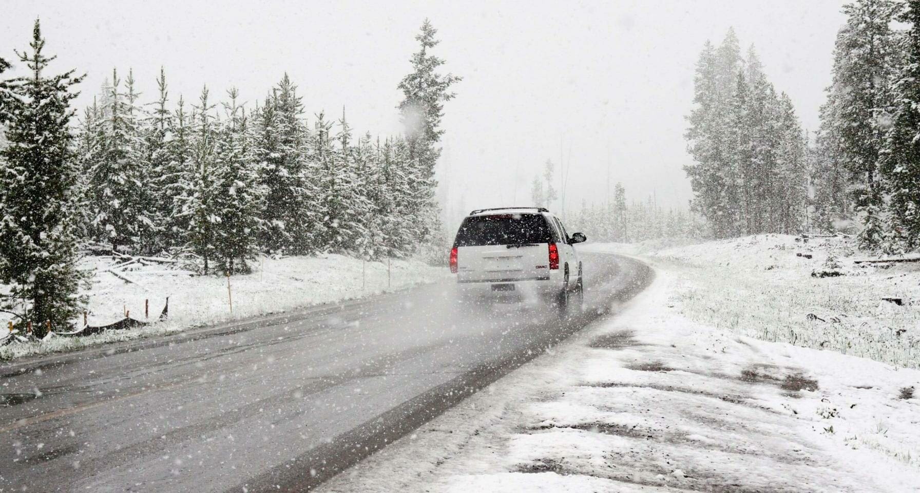 Blog 10 SUV traveling across frozen road in snowy terrain