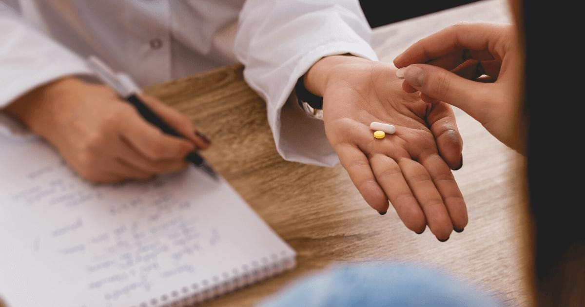 Woman being handed medication