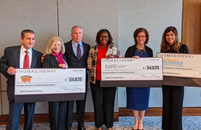 Thomas J. Henry presents donation checks to SAFE, Superhero Kids, and St. David's Foundation Community Fund