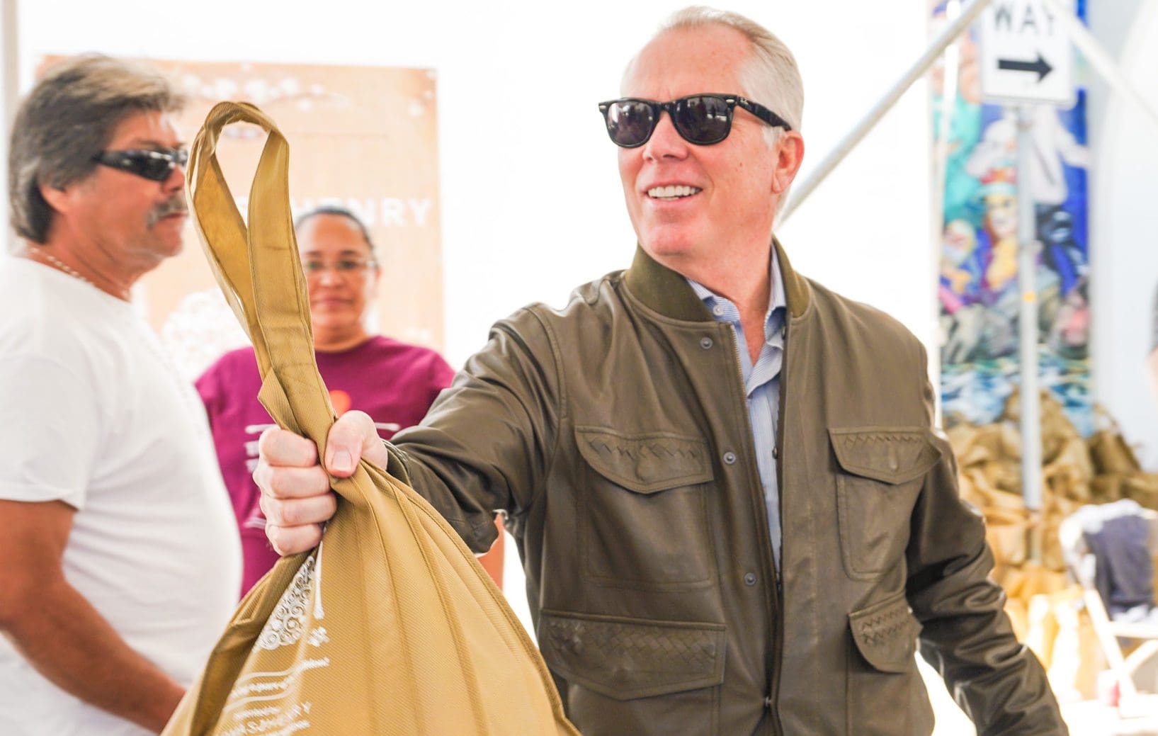 Thomas J. Henry passing out a turkey during the 2019 Annual Turkey Giveaway
